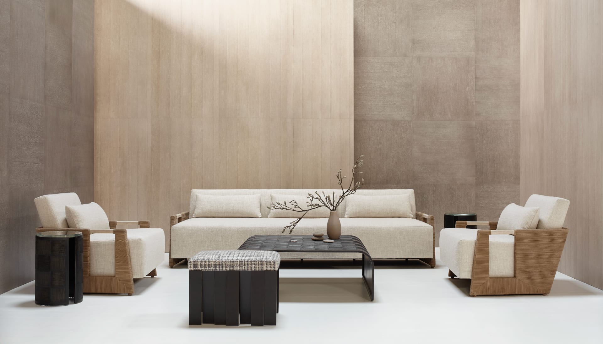 A sculptural figured-walnut sideboard with hand-polished brass pulls, set against limewashed plaster beneath a quiet ochre canvas