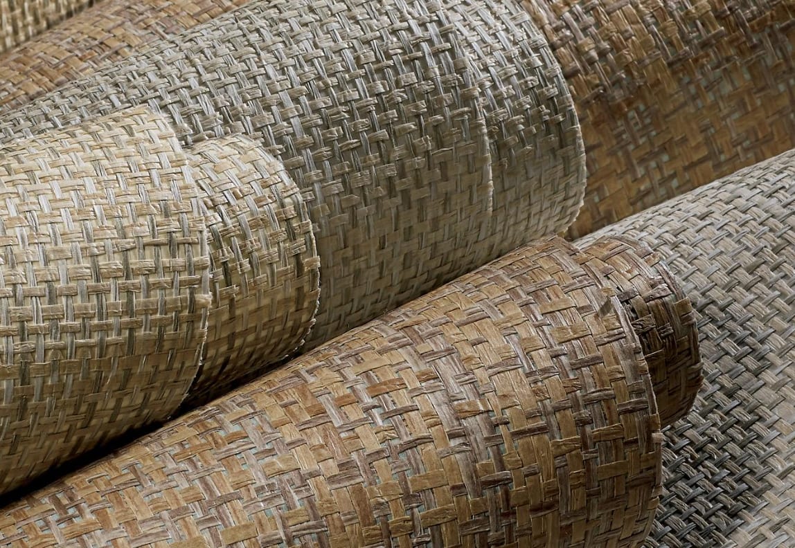 Rolls of hand-woven grasscloth wallcovering in natural tones