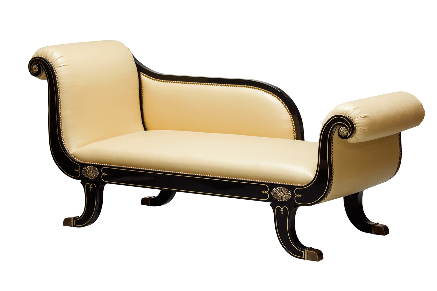 A hand-carved recamier in a quiet corner of an inherited drawing room