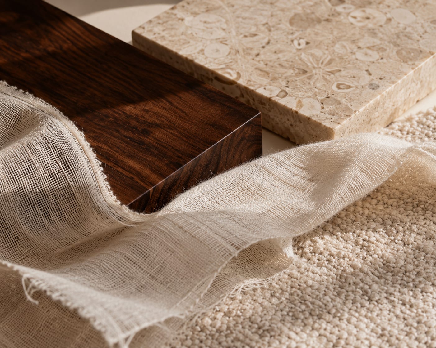 Polished walnut, fossil-veined travertine and a drift of raw linen