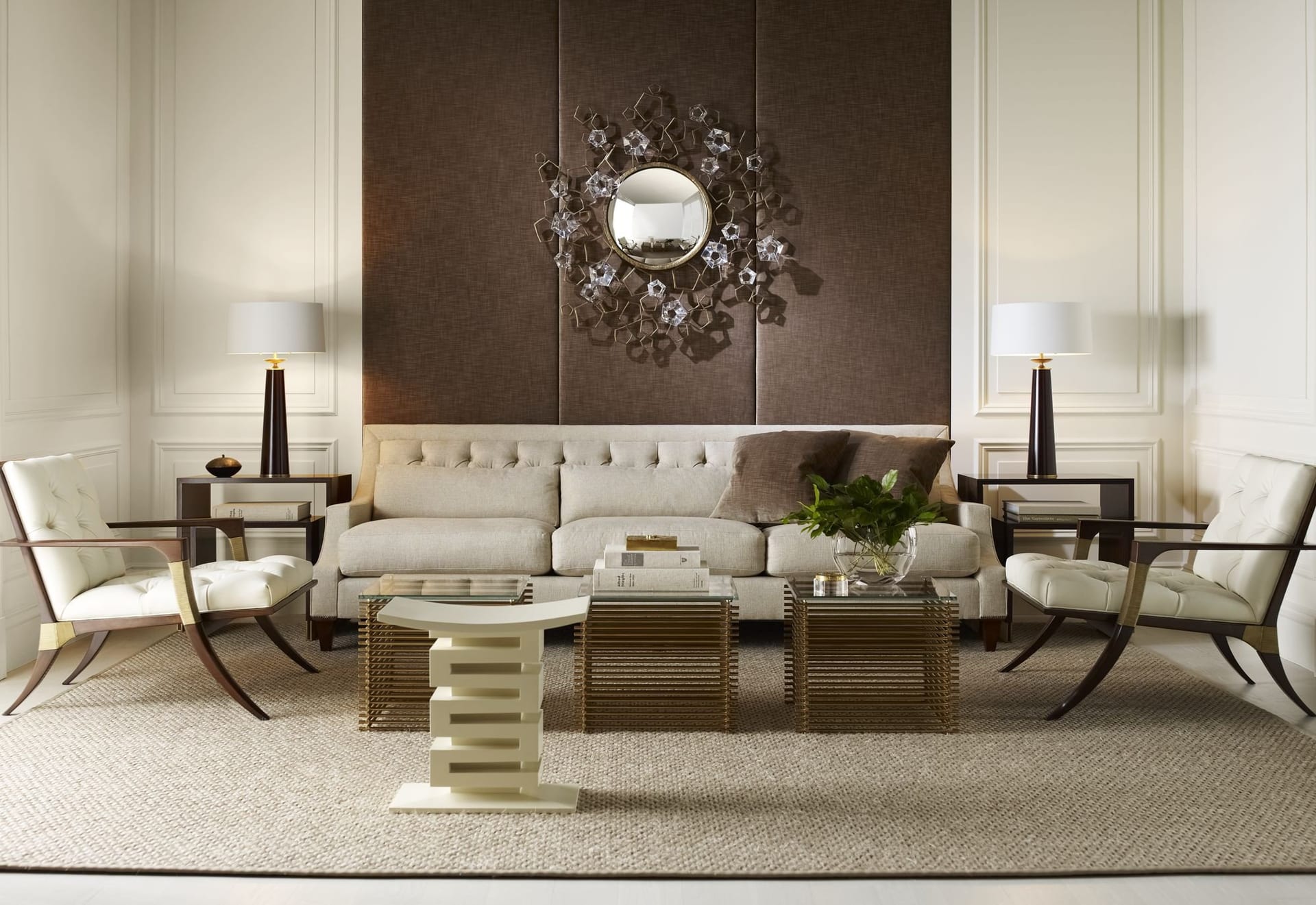 A pale living room — sculptural armchairs, glass-topped table, plaster wall